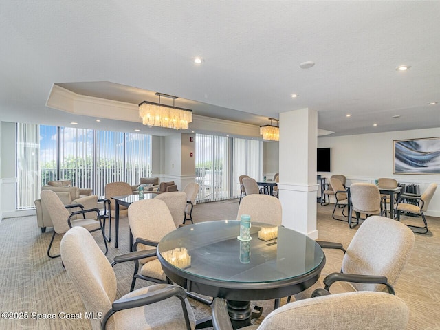 2815 S Atlantic Ave Unit 705, Cocoa Beach, FL 32931 - dining area with a decorative wall, a chandelier, recessed lighting, light colored carpet, and wainscoting