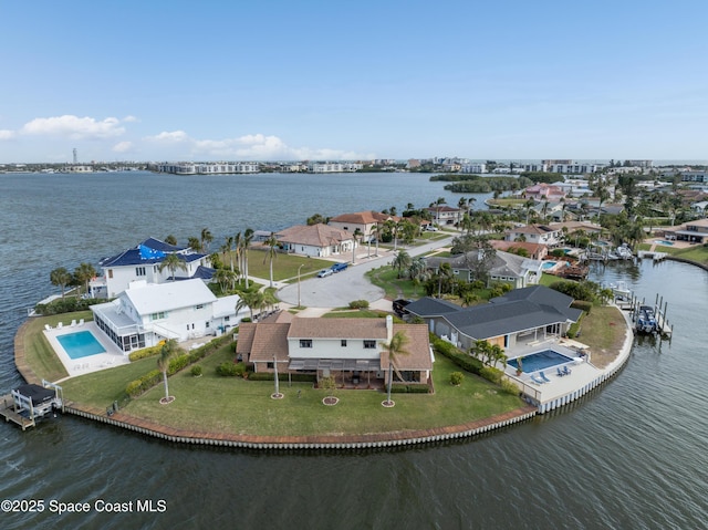 284 Andros Ave, Cocoa Beach, FL 32931 - aerial view of residential area featuring a large body of water and a pool