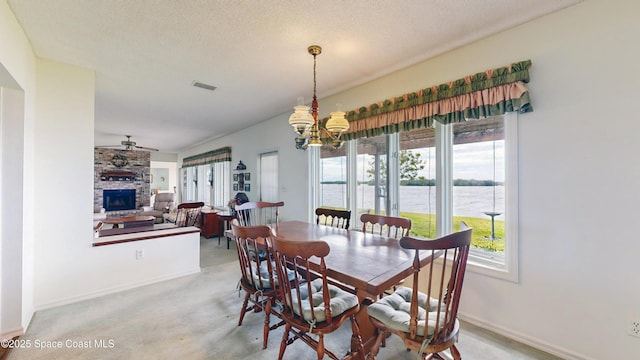 284 Andros Ave, Cocoa Beach, FL 32931 - dining area with a chandelier, a fireplace, baseboards, a ceiling fan, and a textured ceiling