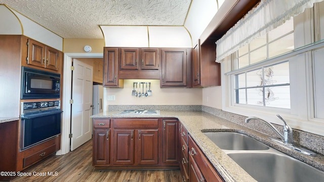 284 Andros Ave, Cocoa Beach, FL 32931 - kitchen featuring black appliances, a sink, dark wood-type flooring, a textured ceiling, and light stone counters