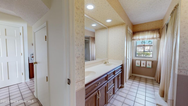 284 Andros Ave, Cocoa Beach, FL 32931 - full bathroom featuring a textured ceiling, double vanity, wallpapered walls, tile patterned flooring, and recessed lighting