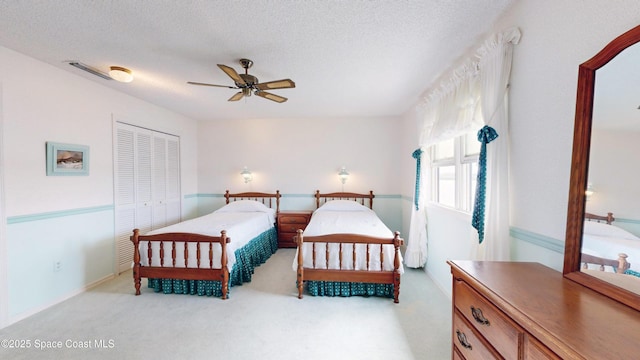 284 Andros Ave, Cocoa Beach, FL 32931 - bedroom featuring light carpet, a closet, a ceiling fan, and a textured ceiling