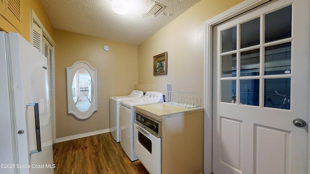 284 Andros Ave, Cocoa Beach, FL 32931 - laundry area featuring washer and clothes dryer, a textured ceiling, dark wood-type flooring, and baseboards