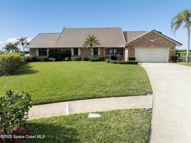 284 Andros Ave, Cocoa Beach, FL 32931 - view of front of property with driveway, an attached garage, a tile roof, and brick siding
