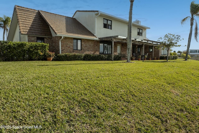 284 Andros Ave, Cocoa Beach, FL 32931 - rear view of house featuring brick siding, a yard, a pergola, and a chimney