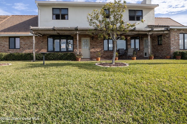 284 Andros Ave, Cocoa Beach, FL 32931 - view of front of home featuring a front yard and brick siding