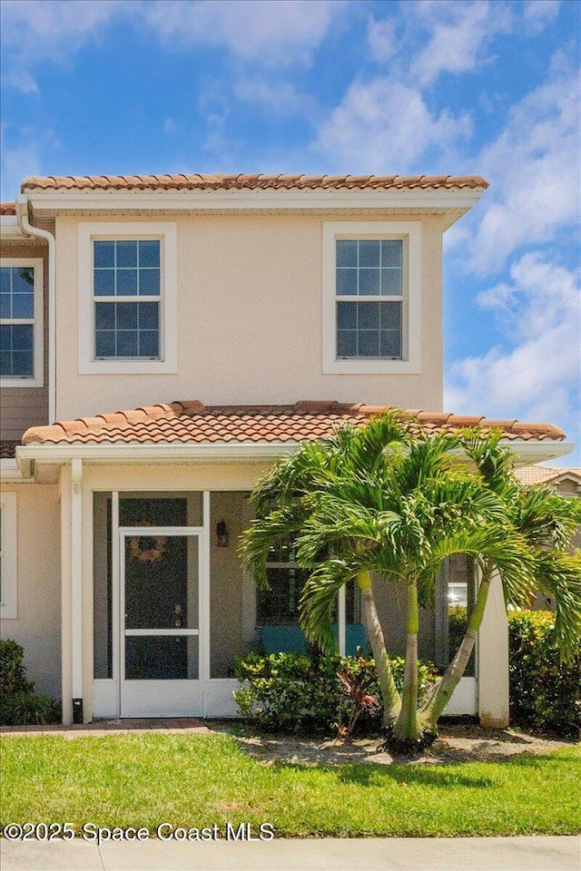 1475 Isabella Dr Unit 101, Melbourne, FL 32935 - mediterranean / spanish-style house with a tile roof and stucco siding