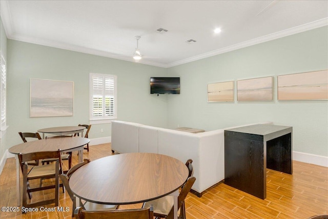1475 Isabella Dr Unit 101, Melbourne, FL 32935 - dining room featuring ornamental molding, a ceiling fan, and light wood-style floors