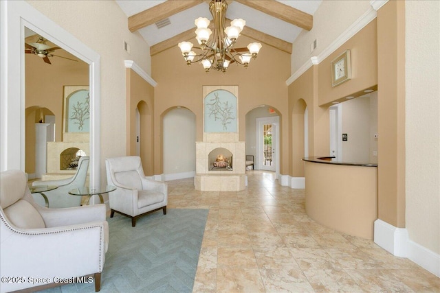 1475 Isabella Dr Unit 101, Melbourne, FL 32935 - living room with high vaulted ceiling, arched walkways, beamed ceiling, a chandelier, and a warm lit fireplace