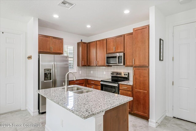 1475 Isabella Dr Unit 101, Melbourne, FL 32935 - kitchen with stainless steel appliances, brown cabinets, light stone countertops, and recessed lighting