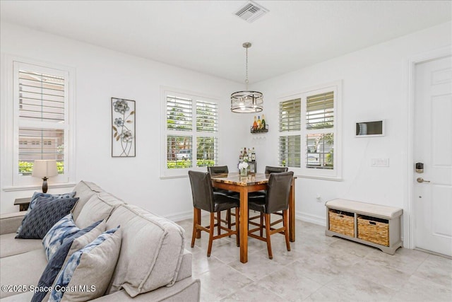 1475 Isabella Dr Unit 101, Melbourne, FL 32935 - dining space with a chandelier and light tile patterned floors
