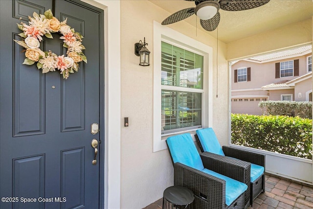 1475 Isabella Dr Unit 101, Melbourne, FL 32935 - doorway to property with stucco siding, a ceiling fan, and covered porch
