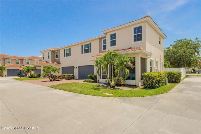 1475 Isabella Dr Unit 101, Melbourne, FL 32935 - view of front of property featuring an attached garage, a tile roof, driveway, and stucco siding