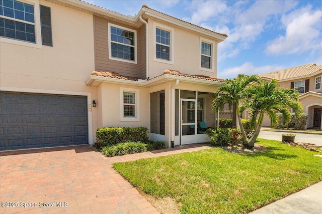 1475 Isabella Dr Unit 101, Melbourne, FL 32935 - mediterranean / spanish home featuring a tiled roof, a sunroom, a front yard, and stucco siding