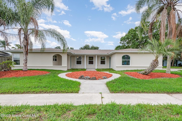 957 Waialae Cir NE, Palm Bay, FL 32905 - ranch-style home featuring stucco siding and a front lawn