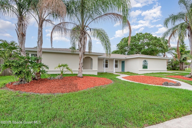 957 Waialae Cir NE, Palm Bay, FL 32905 - ranch-style house with a front lawn and stucco siding