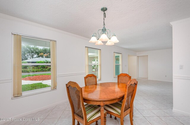 957 Waialae Cir NE, Palm Bay, FL 32905 - dining space with a chandelier, light tile patterned floors, a textured ceiling, crown molding, and baseboards