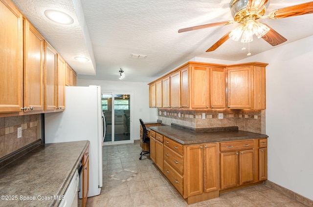957 Waialae Cir NE, Palm Bay, FL 32905 - kitchen featuring a ceiling fan, dark countertops, freestanding refrigerator, and backsplash