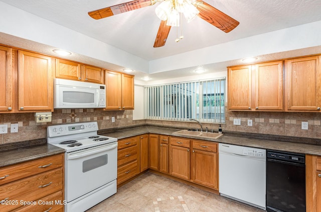 957 Waialae Cir NE, Palm Bay, FL 32905 - kitchen featuring white appliances, a sink, dark countertops, and decorative backsplash