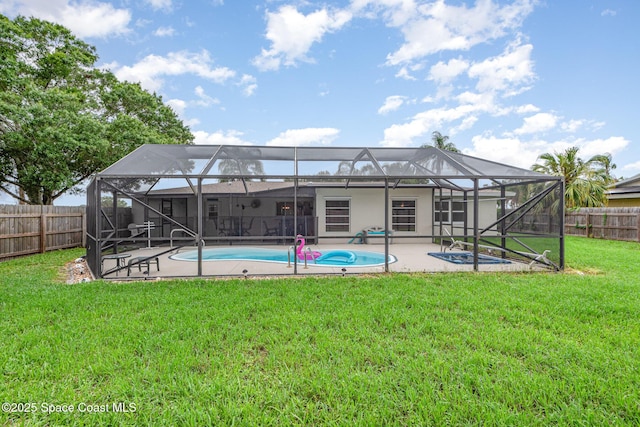 957 Waialae Cir NE, Palm Bay, FL 32905 - back of property with a patio and glass enclosure
