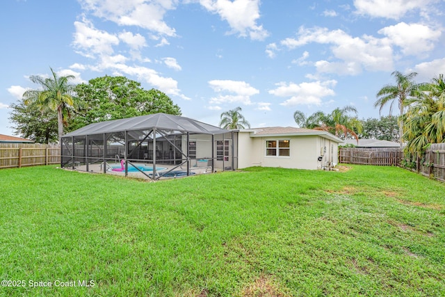 957 Waialae Cir NE, Palm Bay, FL 32905 - back of property with glass enclosure and stucco siding