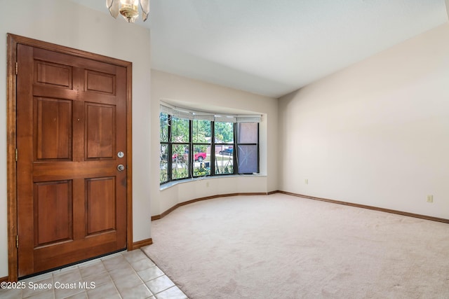 1262 Heberling St NW, Palm Bay, FL 32907 - foyer entrance with light colored carpet, baseboards, and light tile patterned floors