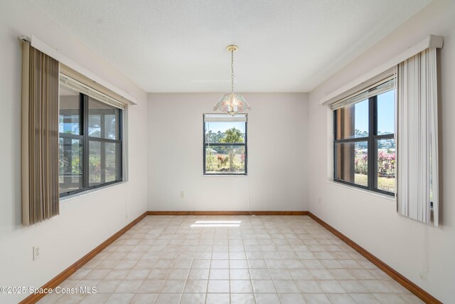1262 Heberling St NW, Palm Bay, FL 32907 - empty room with a chandelier and baseboards
