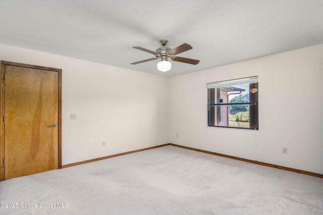 1262 Heberling St NW, Palm Bay, FL 32907 - empty room with light carpet, baseboards, and ceiling fan