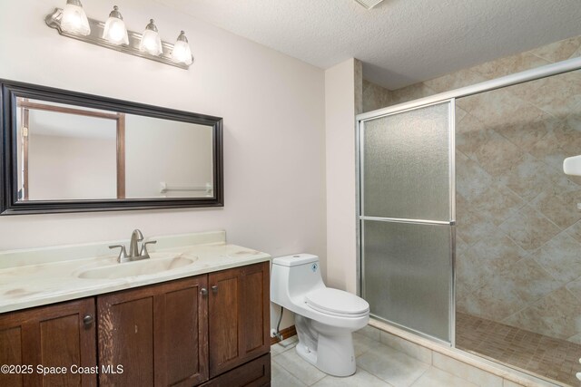 1262 Heberling St NW, Palm Bay, FL 32907 - full bathroom featuring vanity, a shower stall, toilet, tile patterned flooring, and a textured ceiling