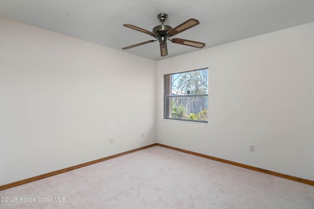 1262 Heberling St NW, Palm Bay, FL 32907 - empty room featuring baseboards, light carpet, ceiling fan, and a textured ceiling