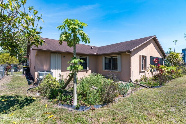 1262 Heberling St NW, Palm Bay, FL 32907 - view of front facade featuring stucco siding and central air condition unit