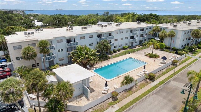 221 Columbia Dr Unit 139, Cape Canaveral, FL 32920 - drone / aerial view of a pool area, apartment complex, and a nearby body of water