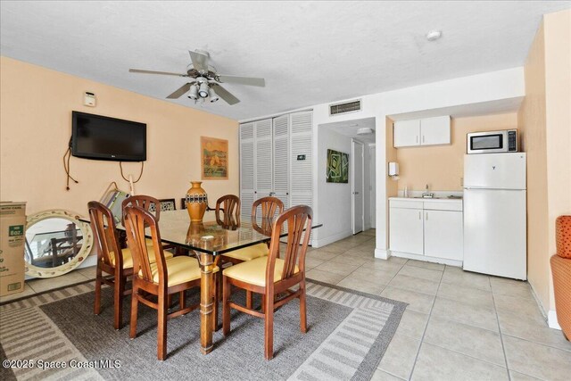 221 Columbia Dr Unit 139, Cape Canaveral, FL 32920 - dining room with a ceiling fan, light tile patterned floors, and baseboards