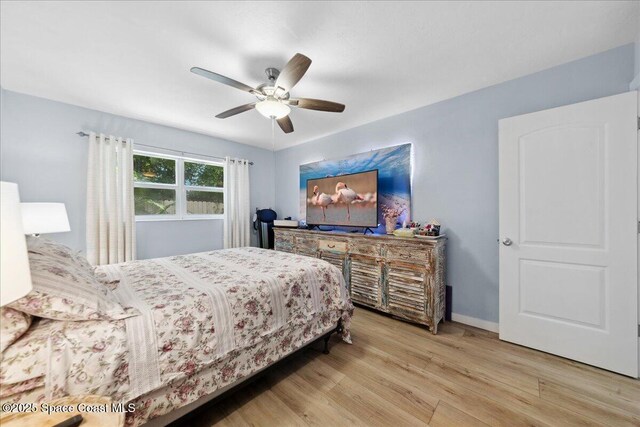 221 Columbia Dr Unit 139, Cape Canaveral, FL 32920 - bedroom with wood finished floors, a ceiling fan, and baseboards