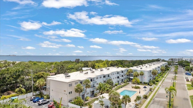 221 Columbia Dr Unit 139, Cape Canaveral, FL 32920 - drone / aerial view of a pool and a nearby body of water