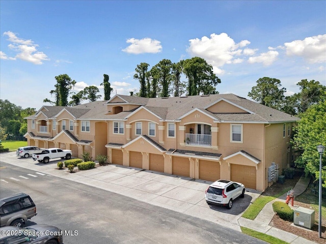 4047 Meander Pl Unit 208, Rockledge, FL 32955 - townhome / multi-family property featuring concrete driveway, a garage, a balcony, and stucco siding