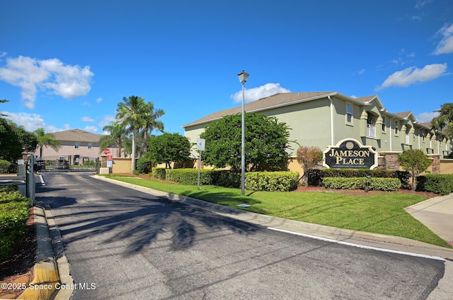 4047 Meander Pl Unit 208, Rockledge, FL 32955 - community sign featuring a residential view, a yard, and a gate
