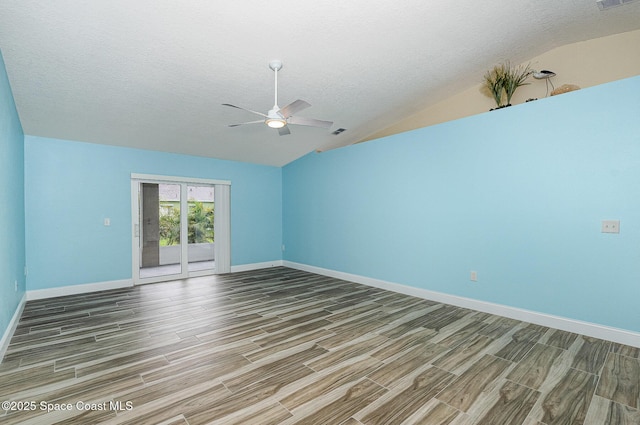 2111 Spring Creek Cir, Palm Bay, FL 32905 - spare room with wood finished floors, ceiling fan, vaulted ceiling, baseboards, and a textured ceiling