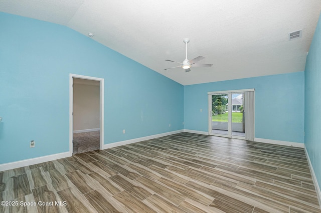 2111 Spring Creek Cir, Palm Bay, FL 32905 - spare room featuring vaulted ceiling, wood tiled floors, a ceiling fan, baseboards, and a textured ceiling