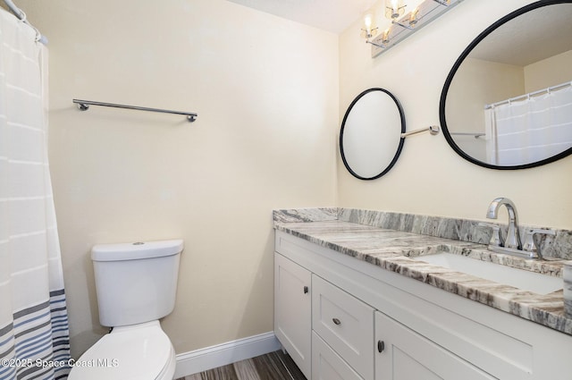 2111 Spring Creek Cir, Palm Bay, FL 32905 - full bathroom featuring vanity, toilet, a chandelier, and baseboards