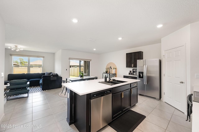 4791 Talbot Blvd, Cocoa, FL 32926 - kitchen with stainless steel appliances, light countertops, a center island with sink, light tile patterned floors, and open floor plan