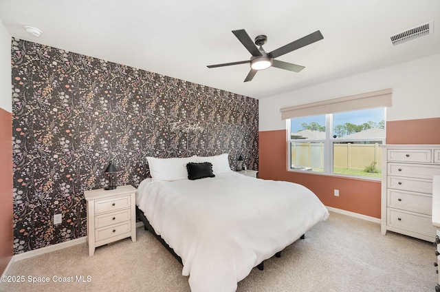 4791 Talbot Blvd, Cocoa, FL 32926 - bedroom with wallpapered walls, light colored carpet, and a ceiling fan