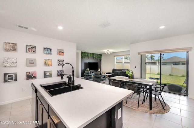4791 Talbot Blvd, Cocoa, FL 32926 - kitchen featuring light countertops, light tile patterned floors, recessed lighting, a center island with sink, and stainless steel dishwasher