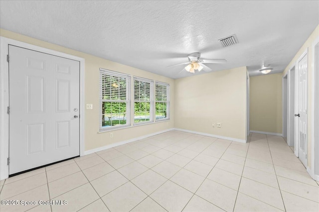 501 Santo Domingo Ave SW, Palm Bay, FL 32908 - foyer entrance featuring ceiling fan, light tile patterned floors, and a textured ceiling