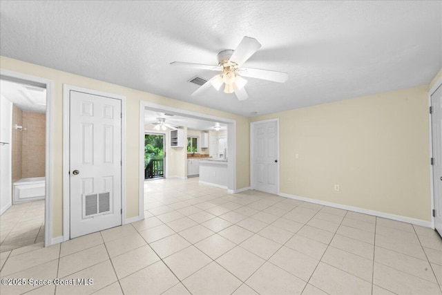 501 Santo Domingo Ave SW, Palm Bay, FL 32908 - empty room featuring ceiling fan, light tile patterned floors, and a textured ceiling