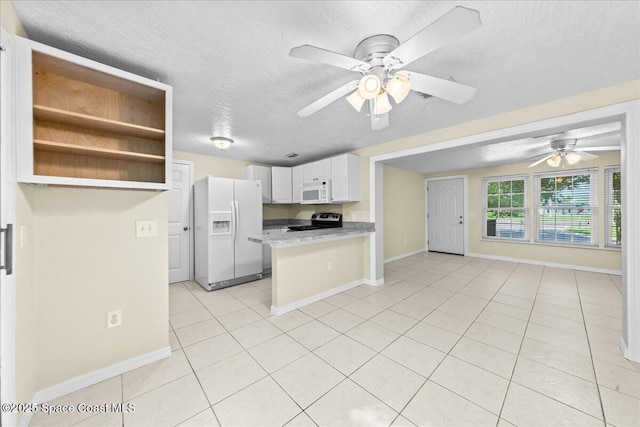 501 Santo Domingo Ave SW, Palm Bay, FL 32908 - kitchen featuring white appliances, a textured ceiling, light tile patterned floors, ceiling fan, and a peninsula