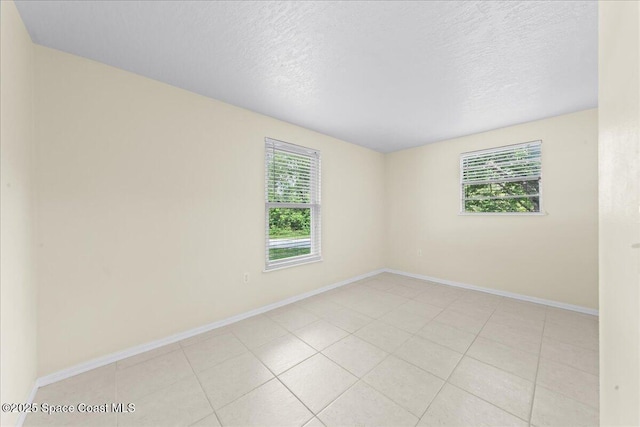501 Santo Domingo Ave SW, Palm Bay, FL 32908 - unfurnished room featuring healthy amount of natural light, a textured ceiling, and light tile patterned floors