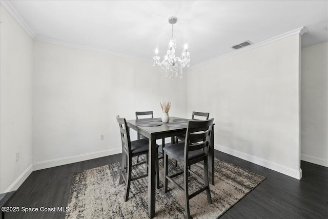 6735 Grissom Pkwy, Cocoa, FL 32927 - dining space featuring wood finished floors, a chandelier, ornamental molding, and baseboards