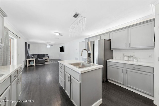 6735 Grissom Pkwy, Cocoa, FL 32927 - kitchen with a sink, gray cabinetry, a kitchen island with sink, open floor plan, and ornamental molding