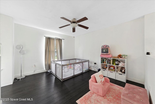 6735 Grissom Pkwy, Cocoa, FL 32927 - bedroom with dark wood-style flooring, baseboards, and a ceiling fan